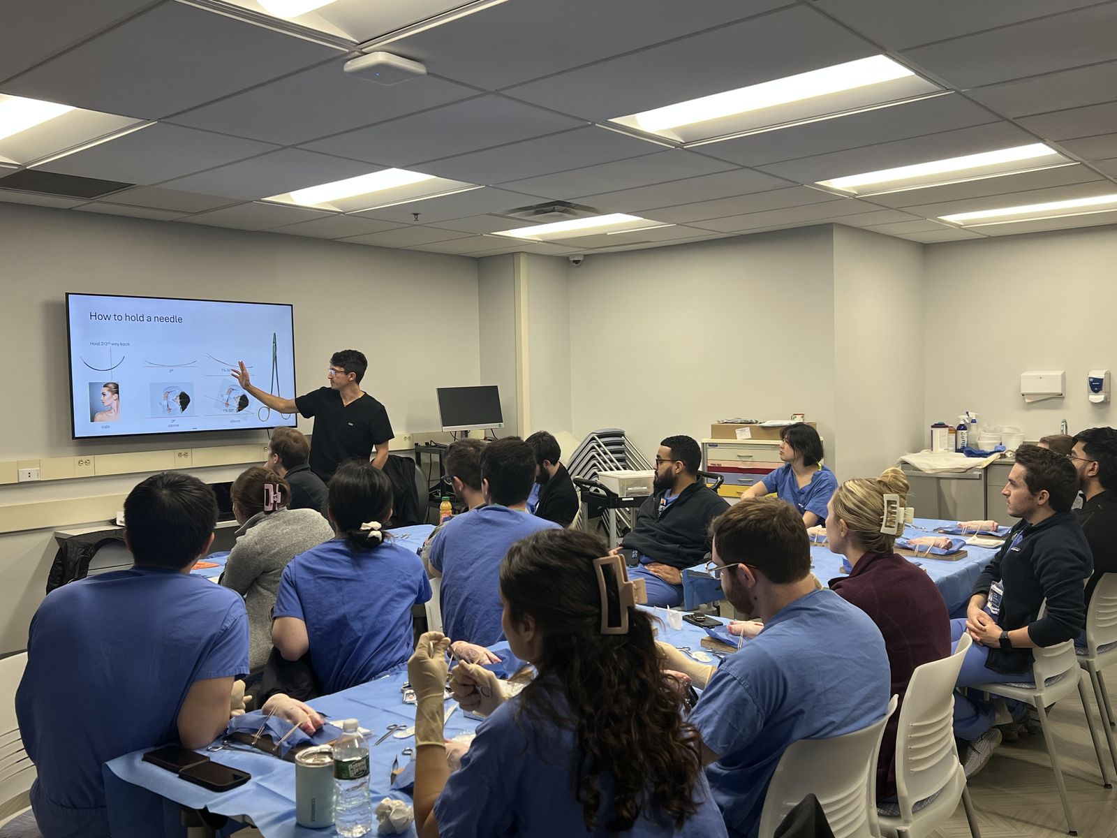 Dr. Andre Rafizadeh leading a hands-on suture training session for incoming surgical residents